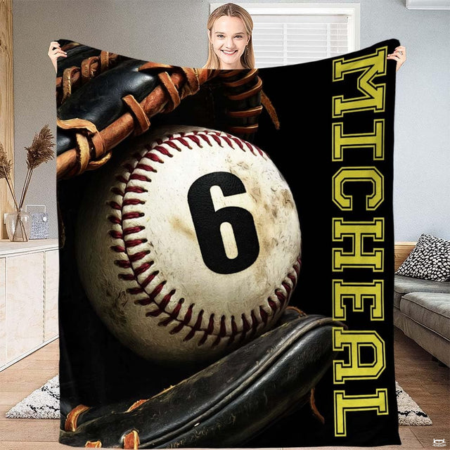 Authentic baseball in a black fielder glove beside vertical gold varsity lettering, view 2.