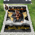 Memorial blanket displaying golden feathered angel wings and glowing clouds on a starry night backdrop.