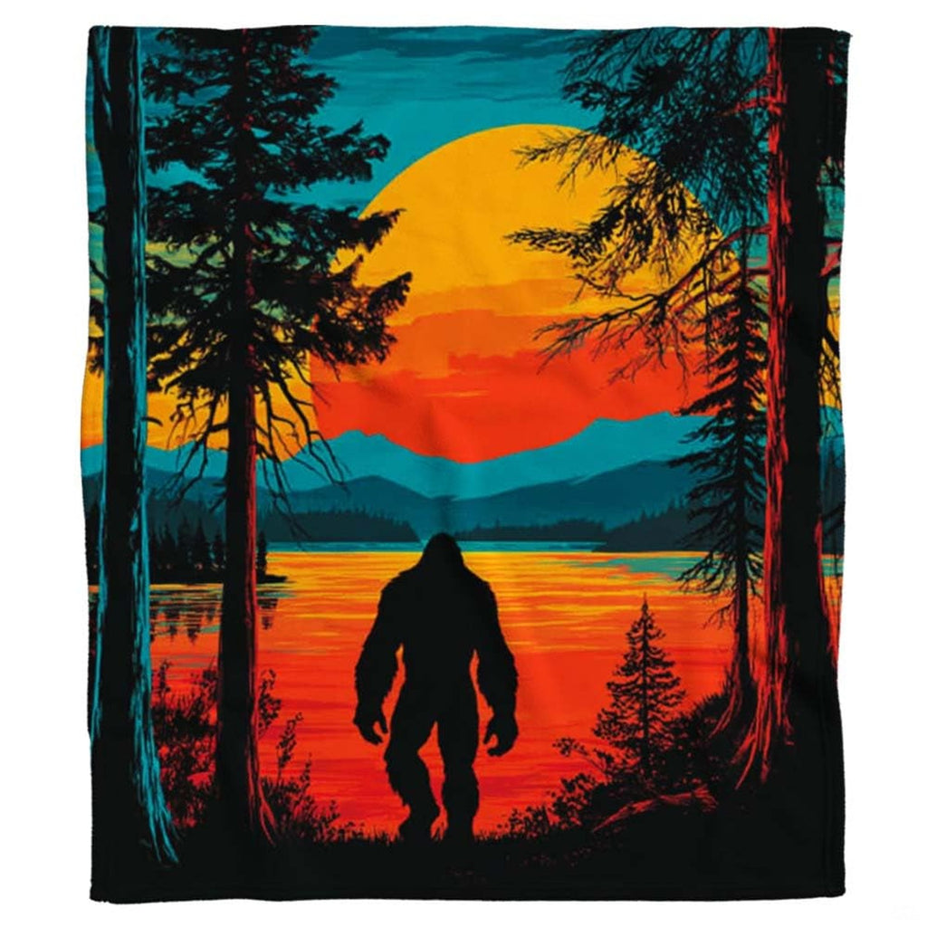 Bigfoot sunset throw blanket draped across a living room couch in a modern home
