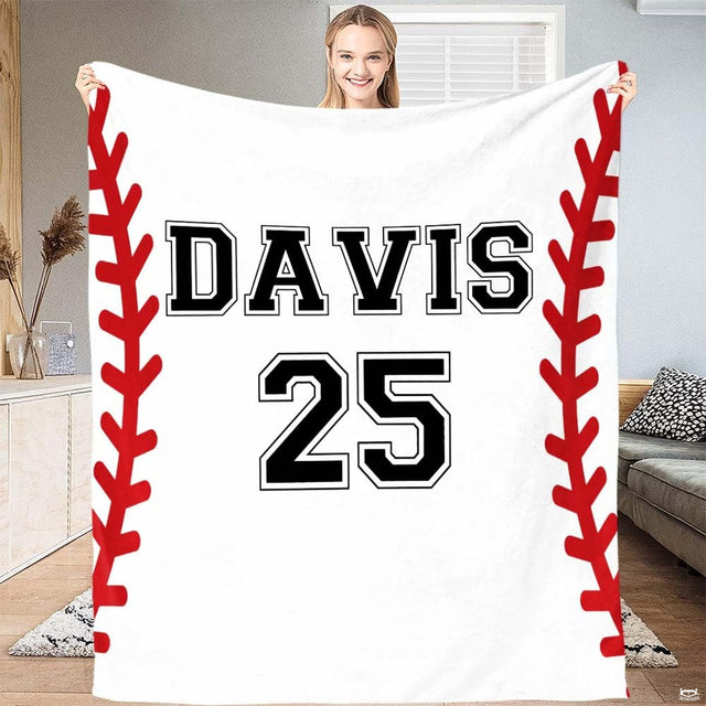 Rustic baseball blanket displayed flat atop a bedroom bed alongside neutral pillows.
