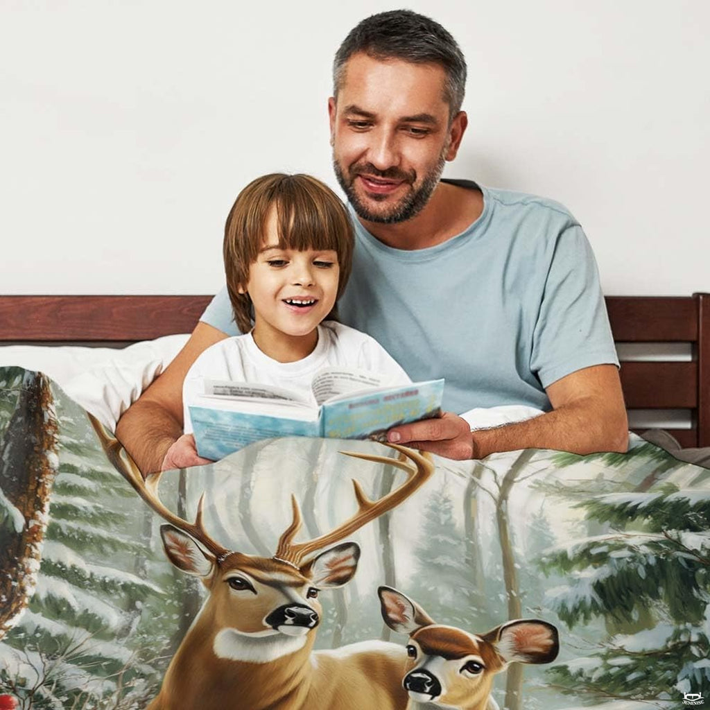 Spotted fawn and majestic buck standing in deep snow with vibrant red winter berry accents across the bedding design.