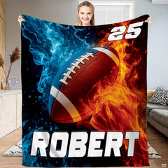 Football blanket held up displaying fire and ice water splash artwork around centered football