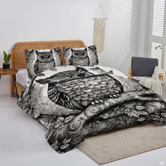 Overhead perspective of owl bedding arranged neatly across a mattress with neutral room decor
