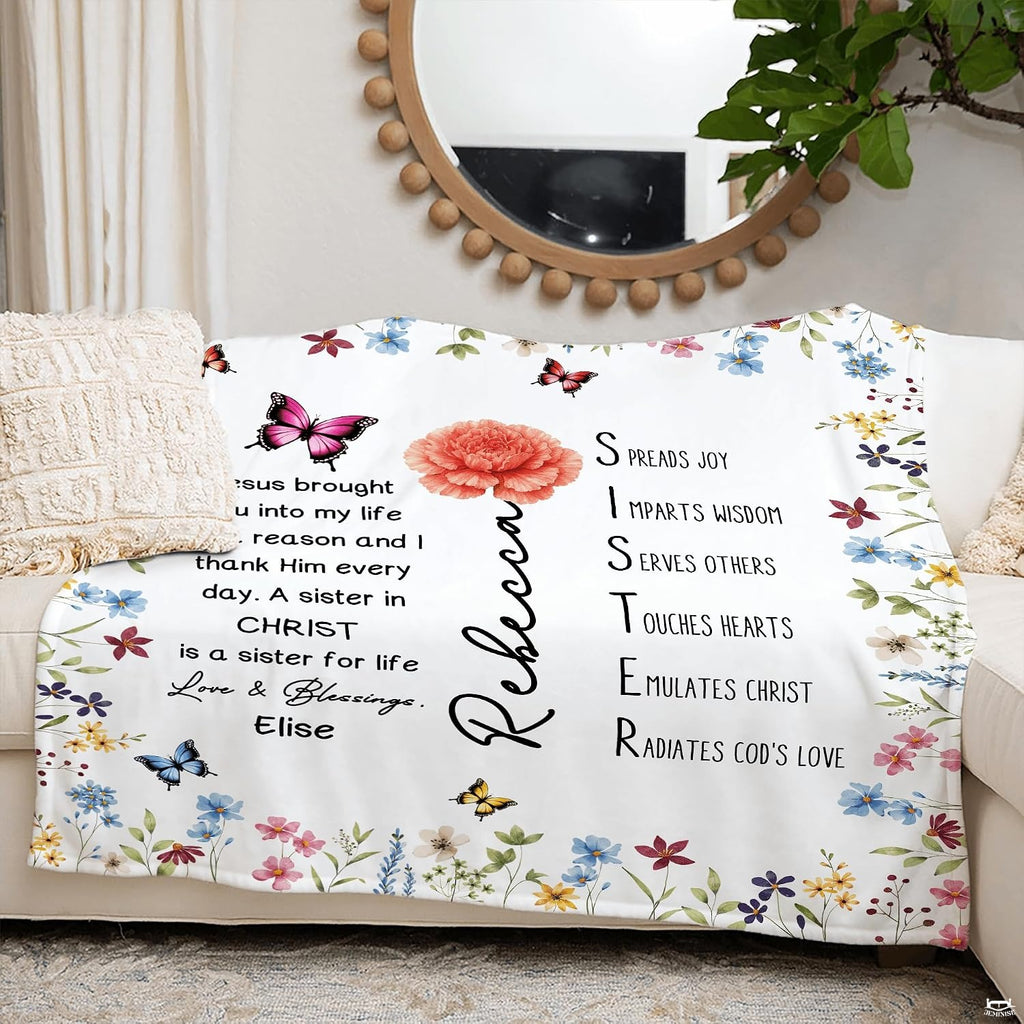 Wildflower butterfly blanket arranged across living room sofa under mirror.