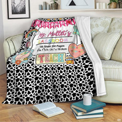 Living room sofa displaying the spotted educator school throw blanket draped over furniture.