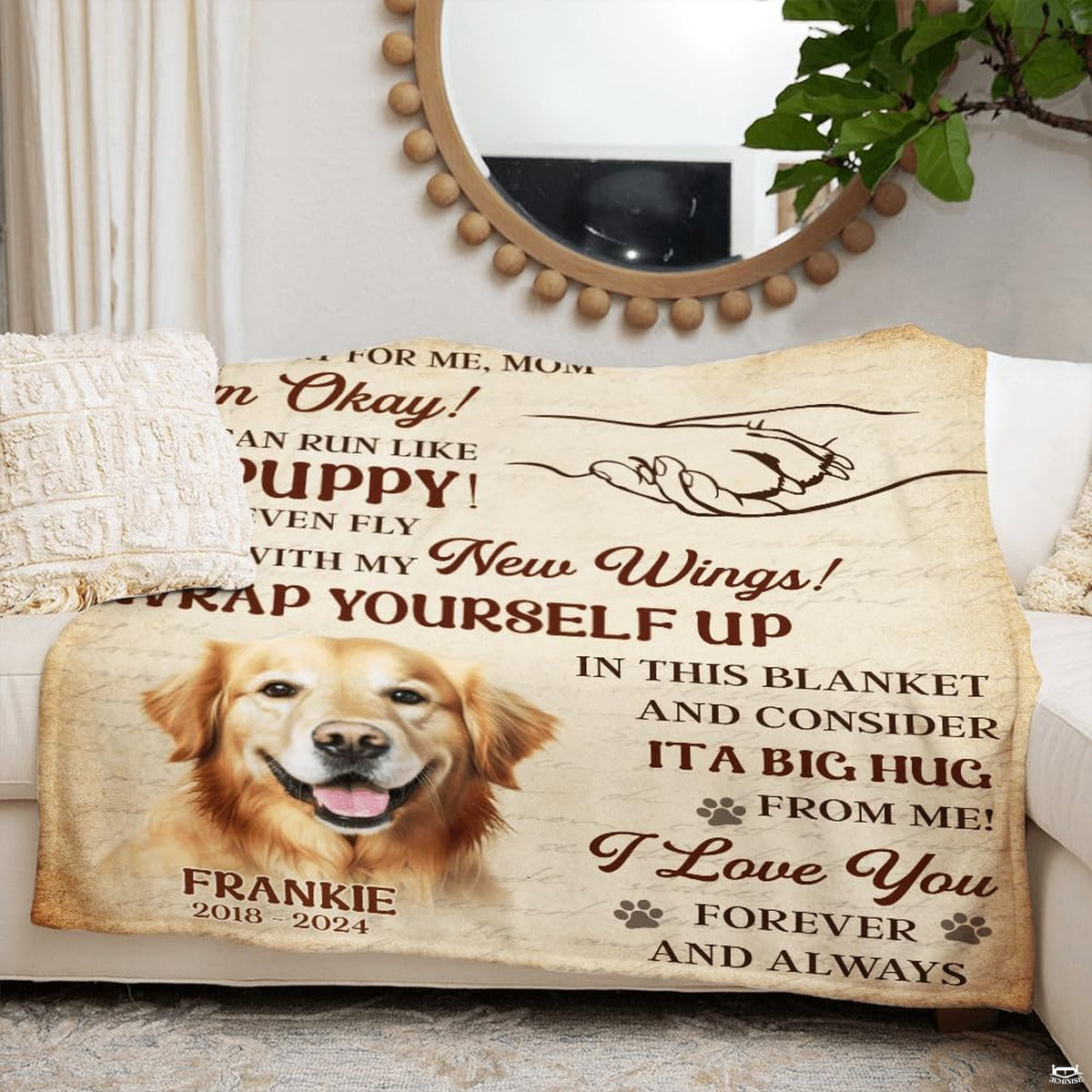 Folded pet sympathy blanket arranged on a rustic wooden bench