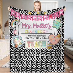 Spotted schoolhouse throw blanket featuring cow print, pink pennant bunting, and school bus stickers.