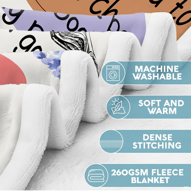 Close-up view of bookish sayings throw blanket highlighting pastel quote shapes and delicate botanical art.