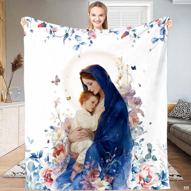 Madonna and Child blanket showing Blessed Virgin holding Baby Jesus framed by blush flowers.