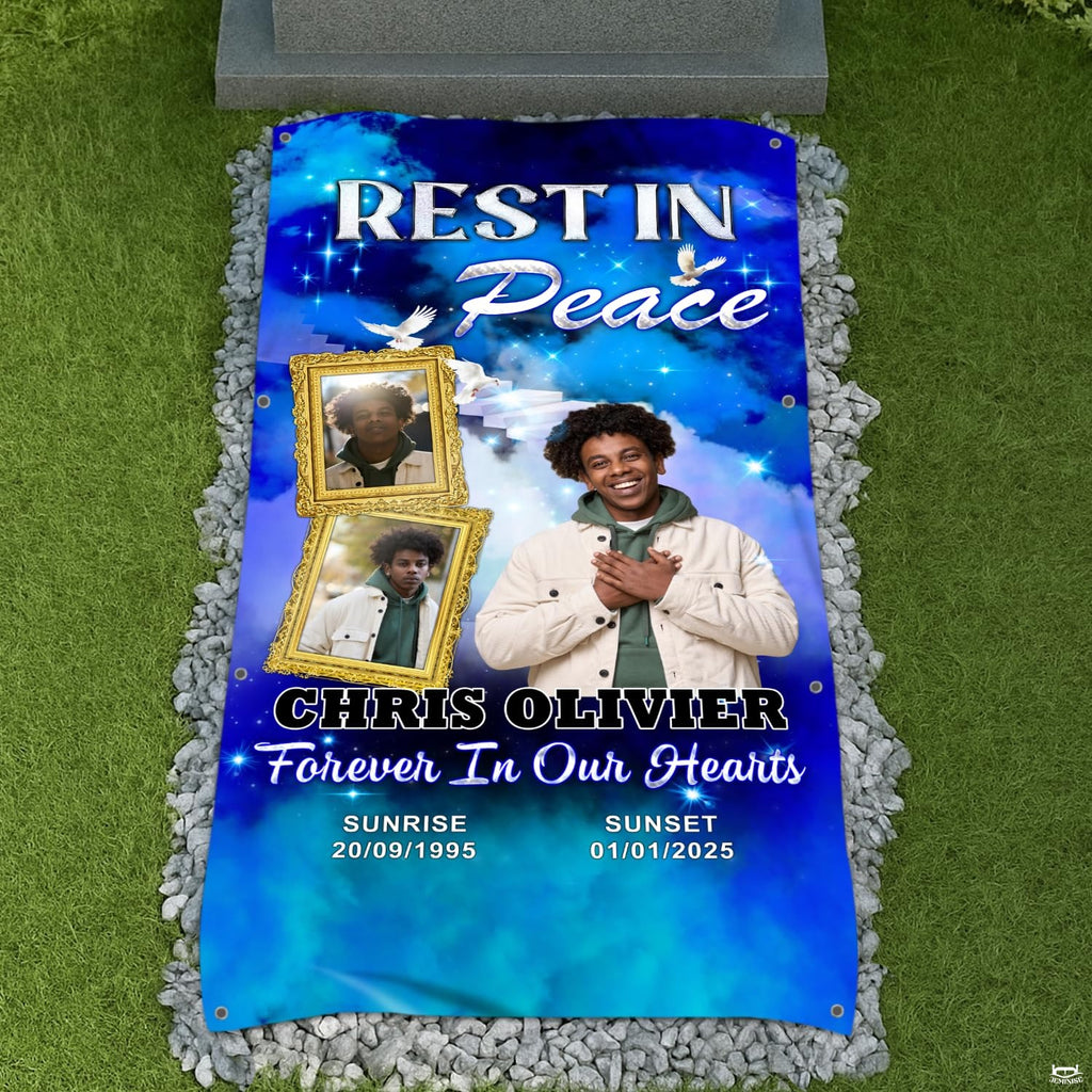 Overhead view of the blue memorial tribute blanket laid on a cemetery lawn surrounded by stones.