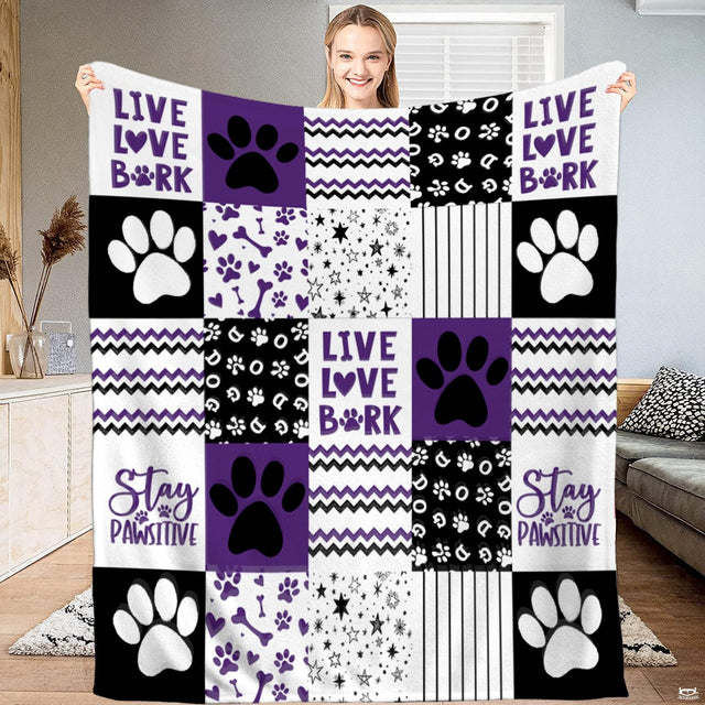 Purple, black, and white patchwork bedding set featuring dog paw prints, bones, hearts, and chevron zigzag waves.