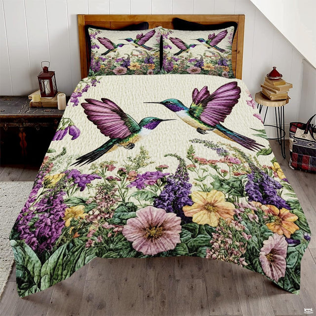 Two teal hummingbirds with lavender wings above a purple wildflower meadow