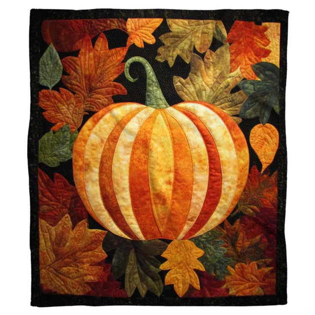 Autumn quilted patchwork pumpkin throw blanket held open by woman