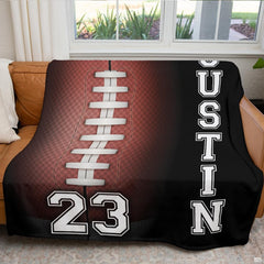 Atmospheric game day fan cave setting featuring American football graphic throw blanket on couch