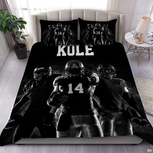 Monochrome black football sports bedding featuring textured football graphic and yard lines on a bed