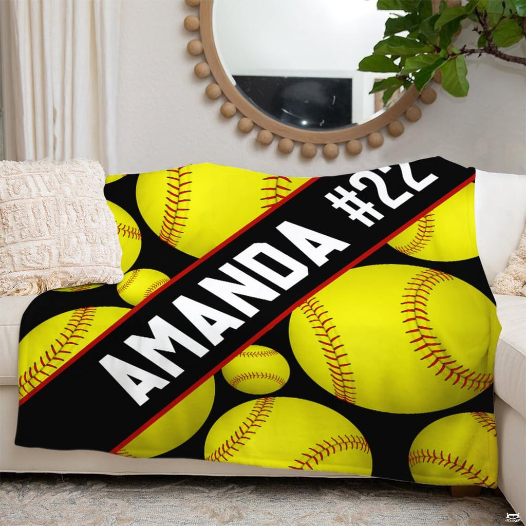 Detail perspective of yellow softball spheres and red seam threads on sports throw blanket.