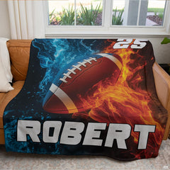 Fire and ice football blanket styled across brown leather couch in modern living room