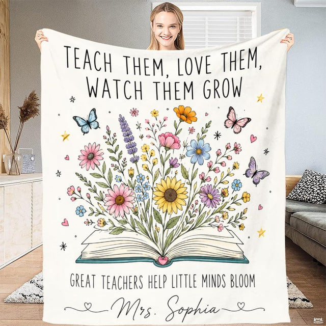 Teacher appreciation throw blanket featuring an open book blooming with wildflowers and butterflies