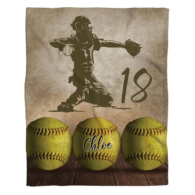 Softball catcher throw blanket showing catcher silhouette and trio of optic yellow softballs on wood.