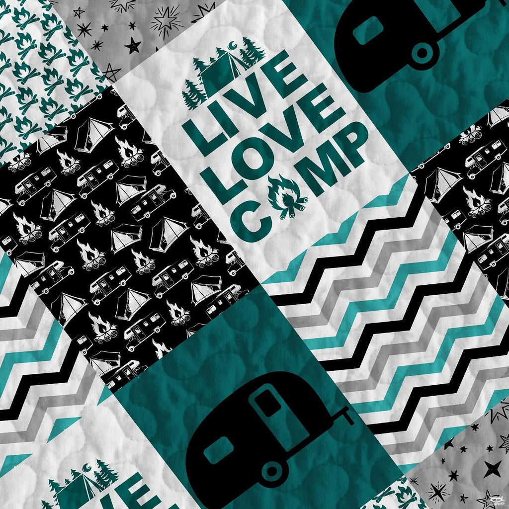 Close-up view of geometric chevron stripes and campfire artwork on a camper bed cover for truck aesthetic.