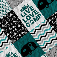 Close-up view of geometric chevron stripes and campfire artwork on a camper bed cover for truck aesthetic.