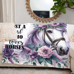 Close-up perspective of purple rose blossoms and white horse bridle on throw blanket