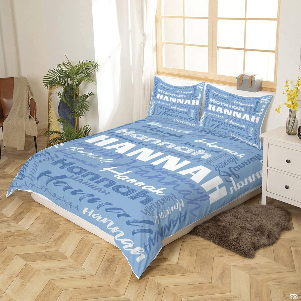 Close-up perspective of periwinkle typography bedding showing textured chalk lettering and calligraphy brushstrokes
