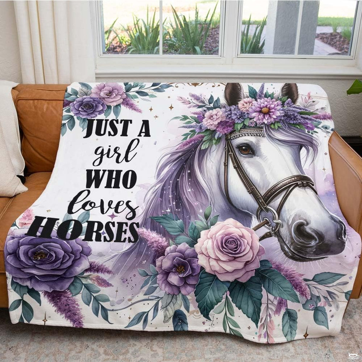 Woman holding open purple floral white horse portrait throw blanket in bright room