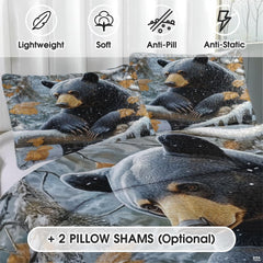 Black bear bedding artwork featuring falling snowflakes and golden autumn oak foliage.