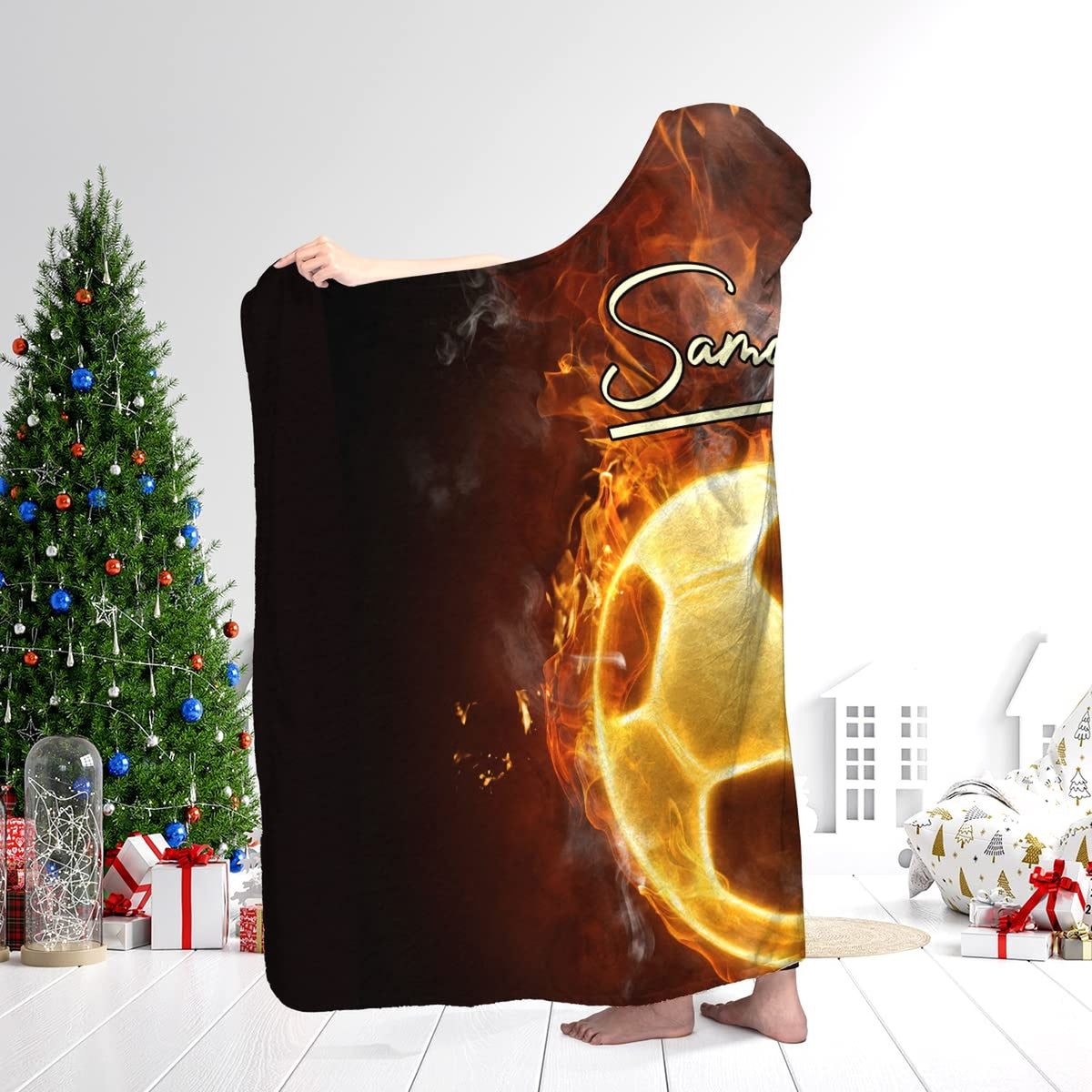Fire soccer sports blanket worn in a living room near a holiday Christmas tree and wrapped presents.