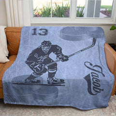 Full frontal display of the hockey player silhouette graphic blanket spread over furniture.