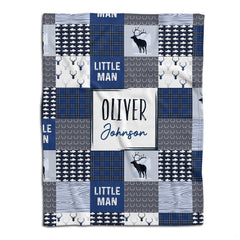 Woodland deer baby blanket displayed flat showing blue rustic patchwork squares highlighting stag and fish motifs