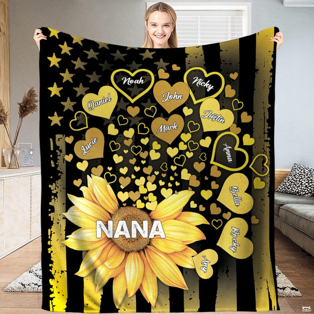 Person presenting the golden sunflower design with floating heart petals over flag stripes.