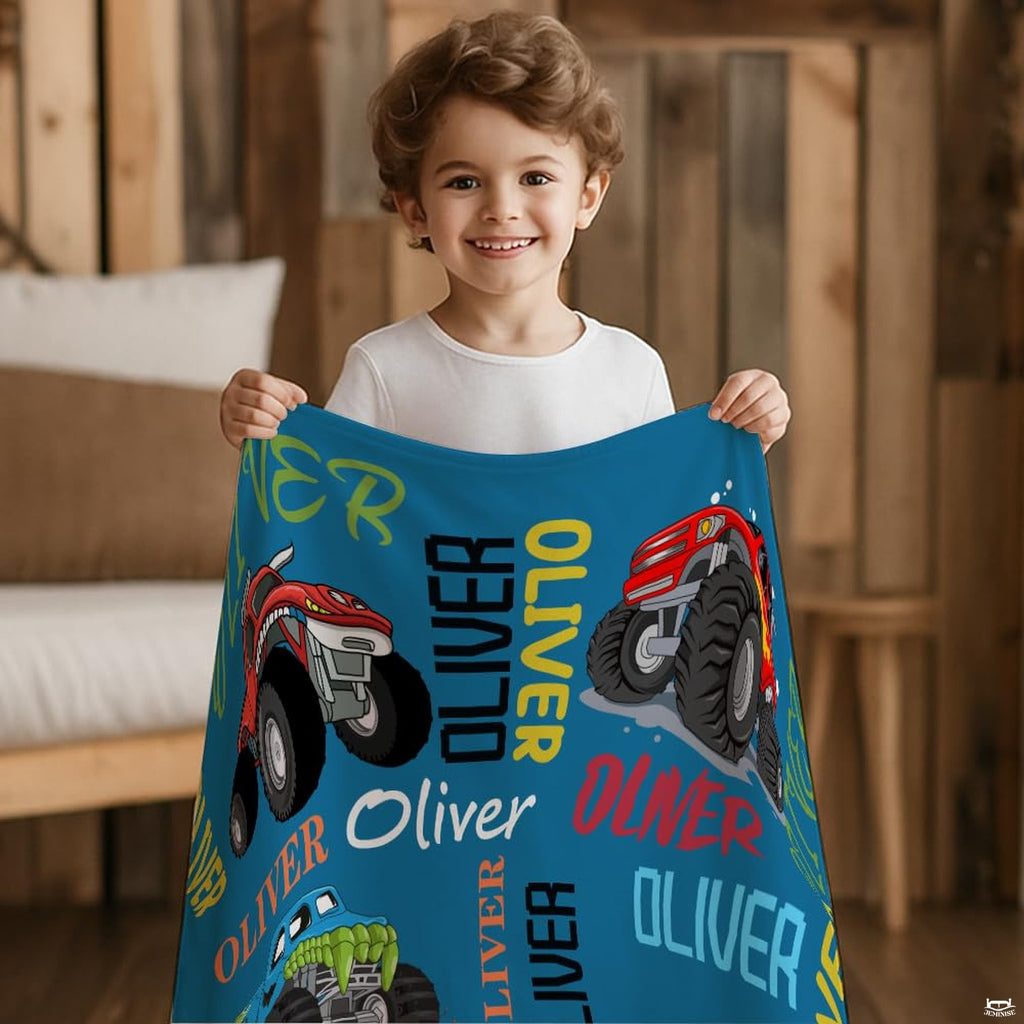 Atmospheric playroom couch setting featuring colorful cartoon monster trucks throw blanket
