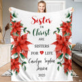 Red poinsettia floral holiday blanket displayed indoors.