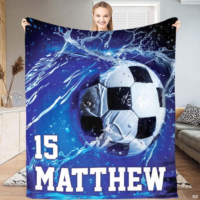 Soccer blanket held up showcasing electric blue water splash soccer ball graphic