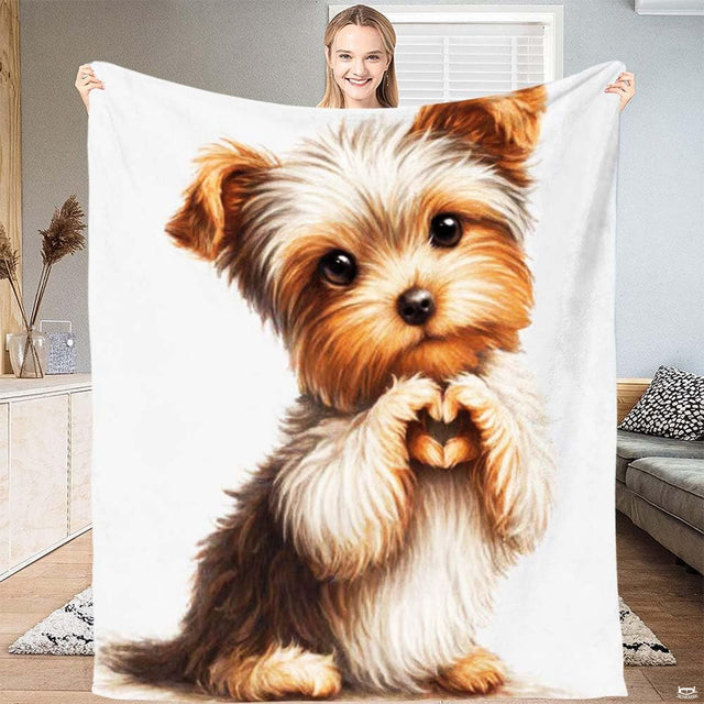 Cute puppy bedding featuring upright Yorkshire terrier puppy making heart paws on white background.