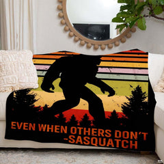 thematic accent forest artwork with red, orange, and green stripes on black bedding.