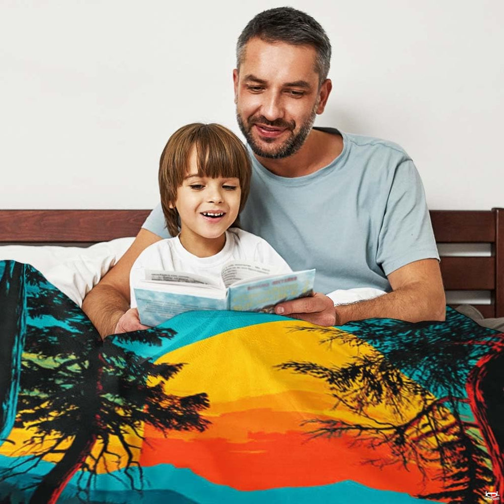 Close-up detail of the printed glowing sunset, water reflections, and Bigfoot silhouette on the throw blanket