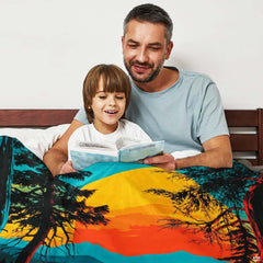 Close-up detail of the printed glowing sunset, water reflections, and Bigfoot silhouette on the throw blanket