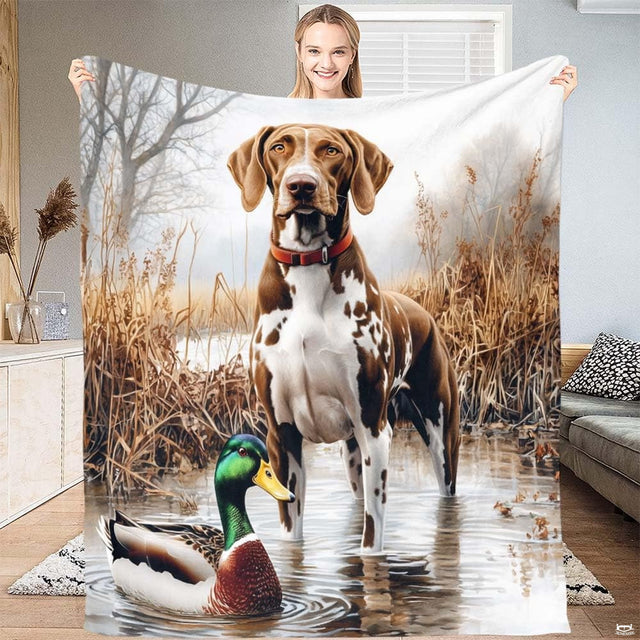 Hunting pointer dog throw blanket draped over living room sofa showing wetland landscape