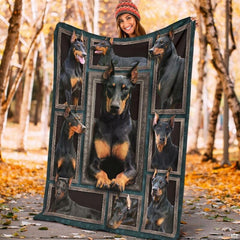 Model displaying the rectangular Doberman Pinscher portrait blanket outdoors in an autumn park.