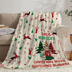 Living room staging of reindeer holiday throw blanket draped across a neutral sofa.