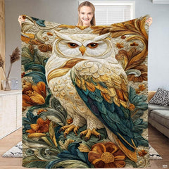 Baroque embossed white owl with golden and teal wing feathers among carved foliage on a throw blanket