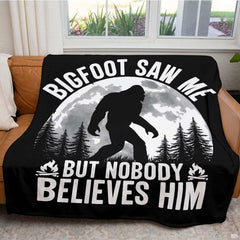 Close up of nocturnal Bigfoot throw blanket highlighting cloudy full moon and evergreen pine tree details