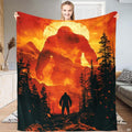 Fiery Bigfoot Sasquatch towering over mountain ridges and pine trees, view 1.