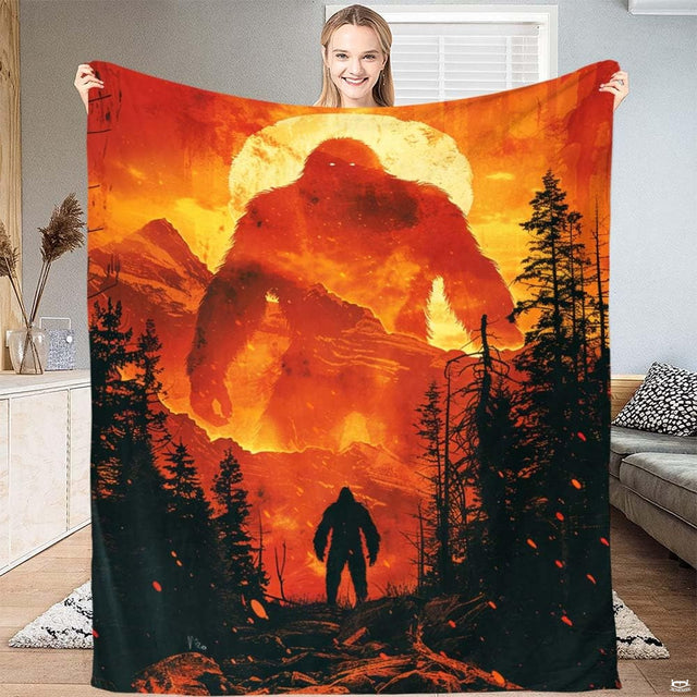 Fiery Bigfoot Sasquatch towering over mountain ridges and pine trees, view 1.