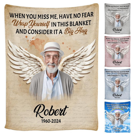 Front view of angel wings memorial throw blanket held upright showcasing feathered wings and verse.