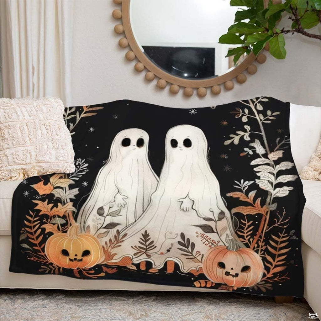 Close-up of thematic accent ghost Halloween bedding showcasing cream ghosts, thematic accent autumn branches, and star...