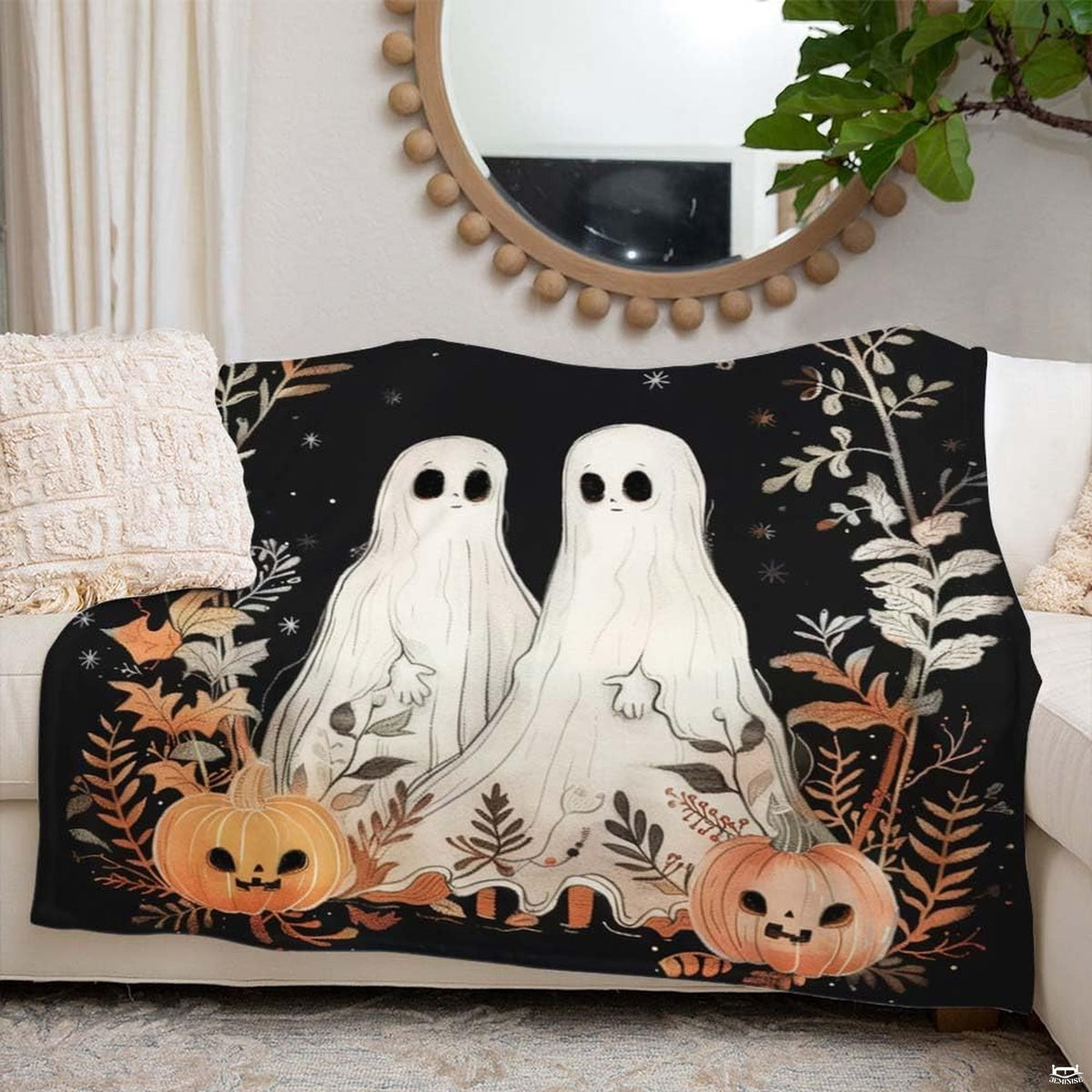 Close-up of thematic accent ghost Halloween bedding showcasing cream ghosts, thematic accent autumn branches, and star...